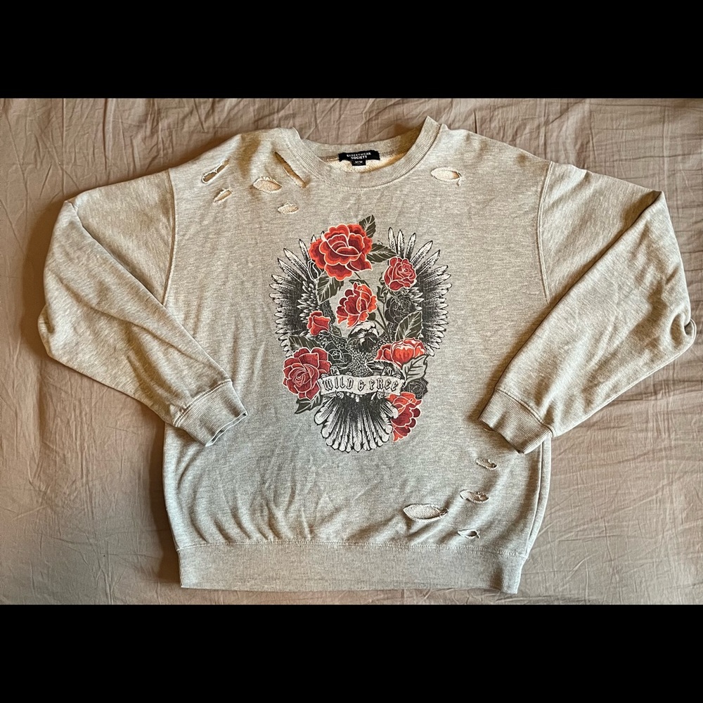 Grey sweater, lightly distressed but was designed like that